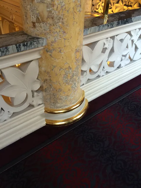 Gold leaf defining the base of a faux-marble column