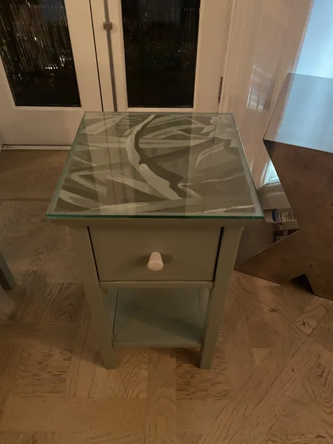 Decorative botanical tabletop beneath glass