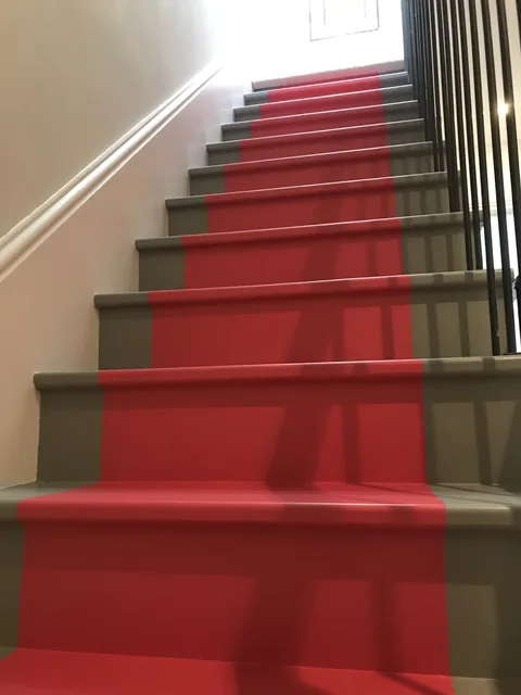 Red runner and grey staircase in finished contrast