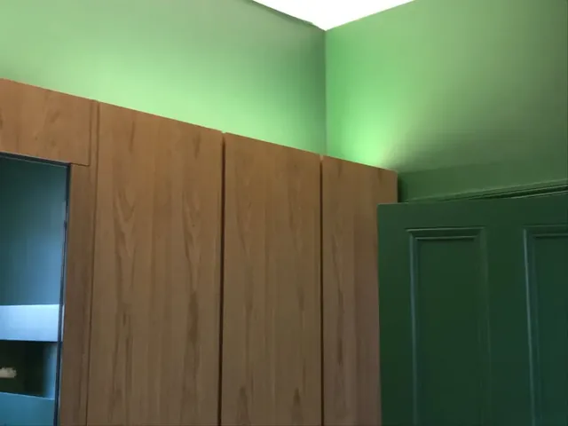 Hand-blended green paint finish beneath concealed lighting, Hampstead